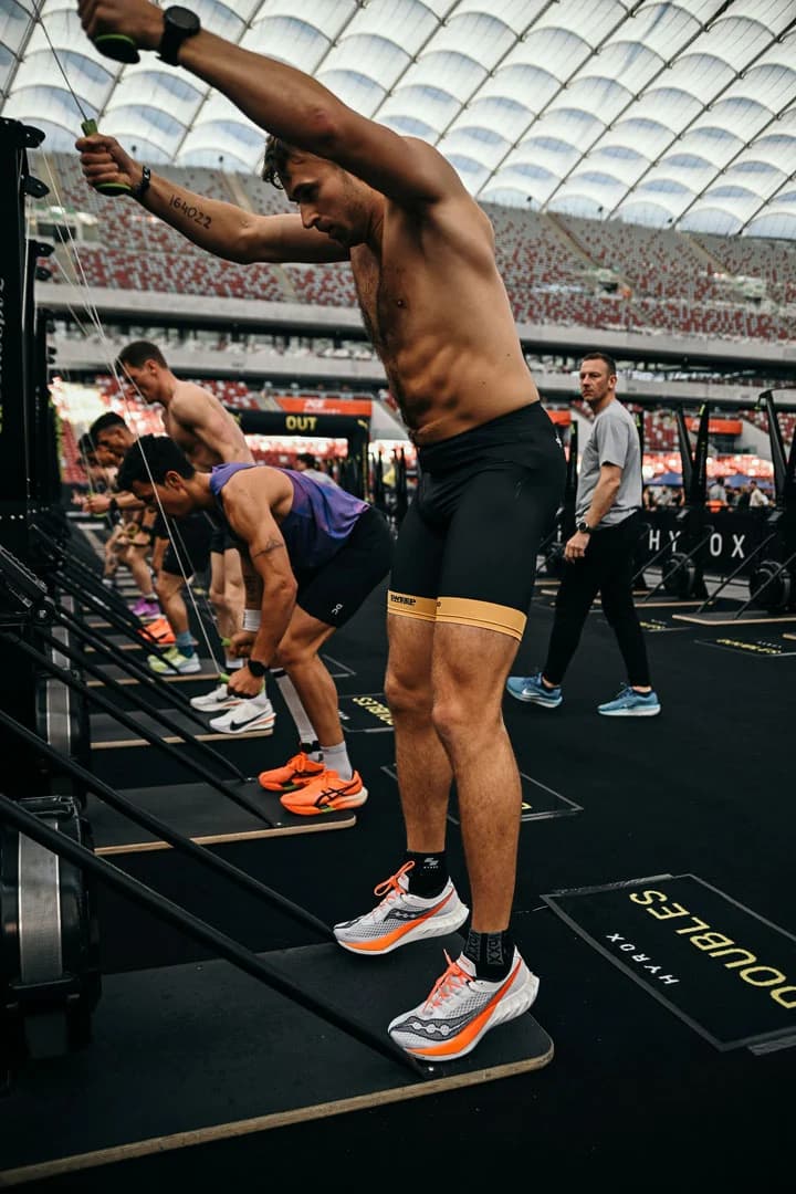 HYROX athlete gripping kettlebells during the farmers carry station